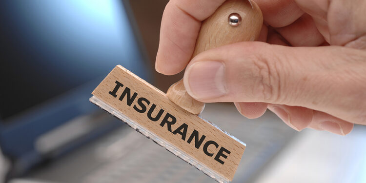 rubber stamp in hand with inscription INSURANCE
